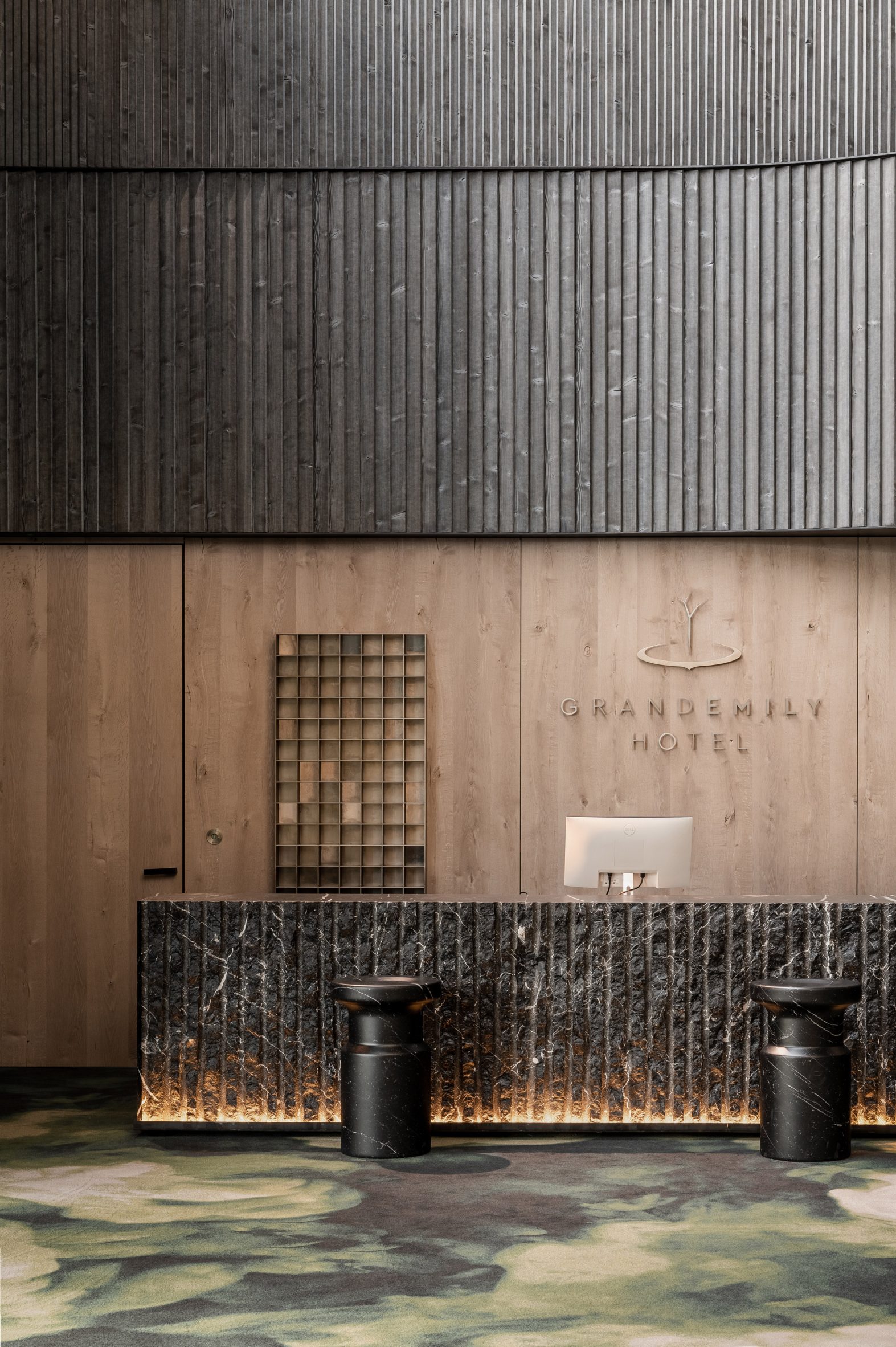 Thermory wood cladding above welcome desk