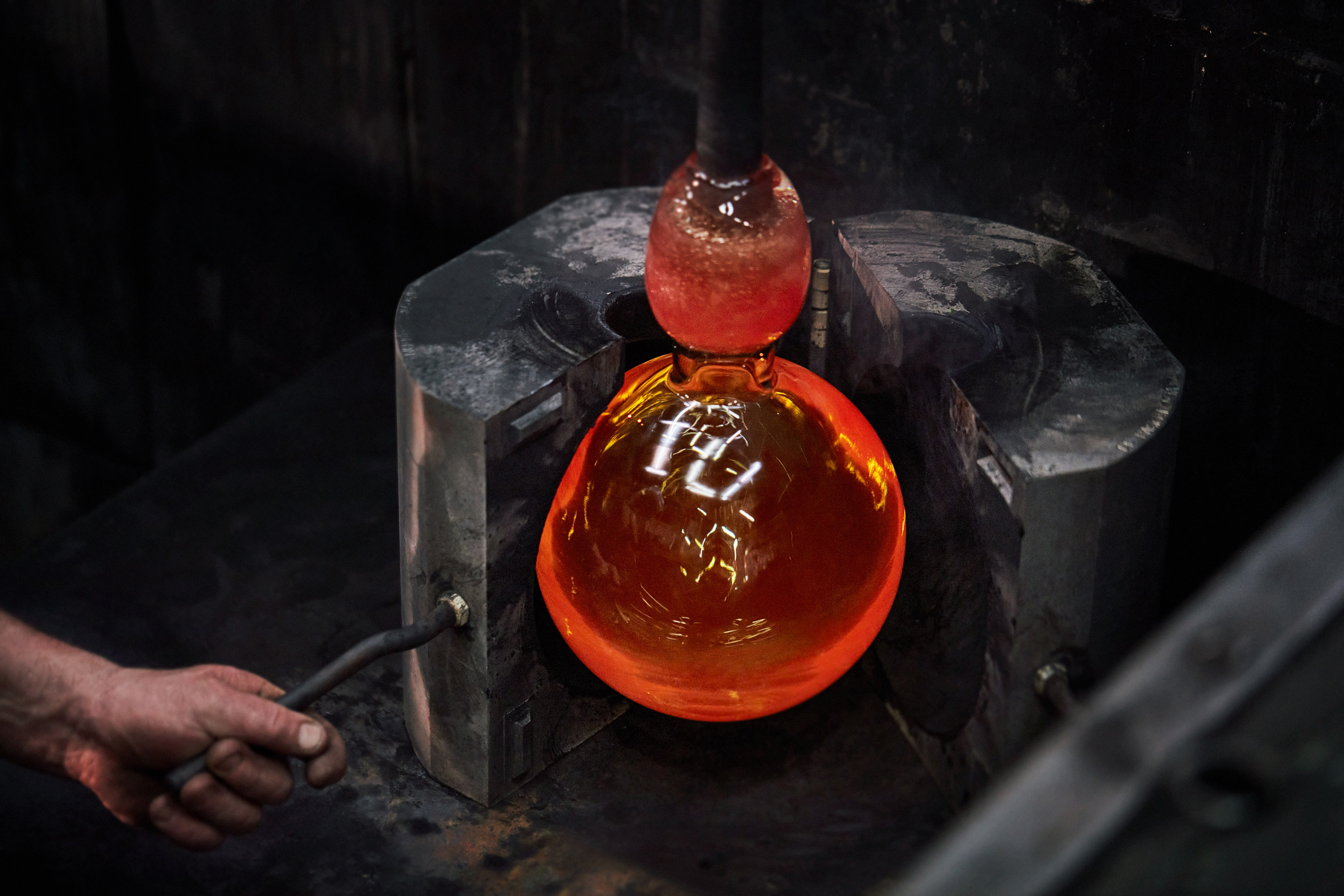 Glass sphere being forged
