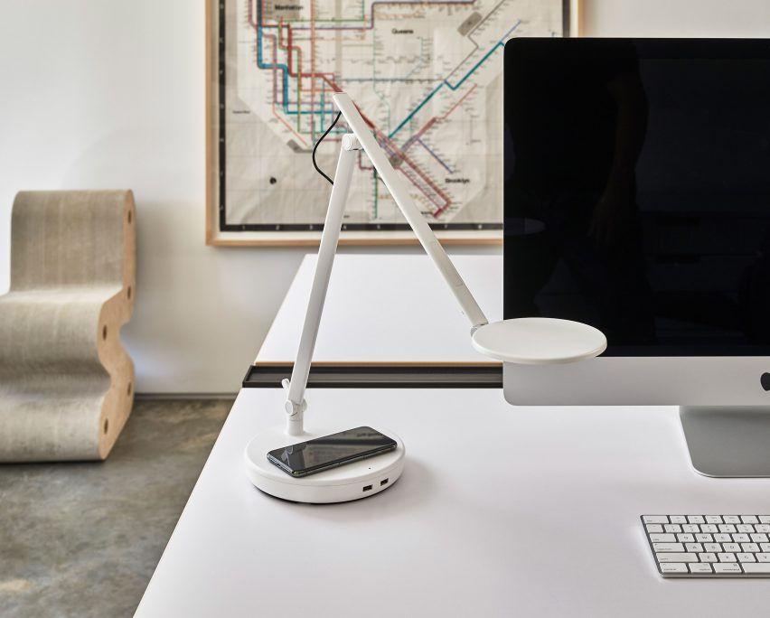 A white desk lamp on a table