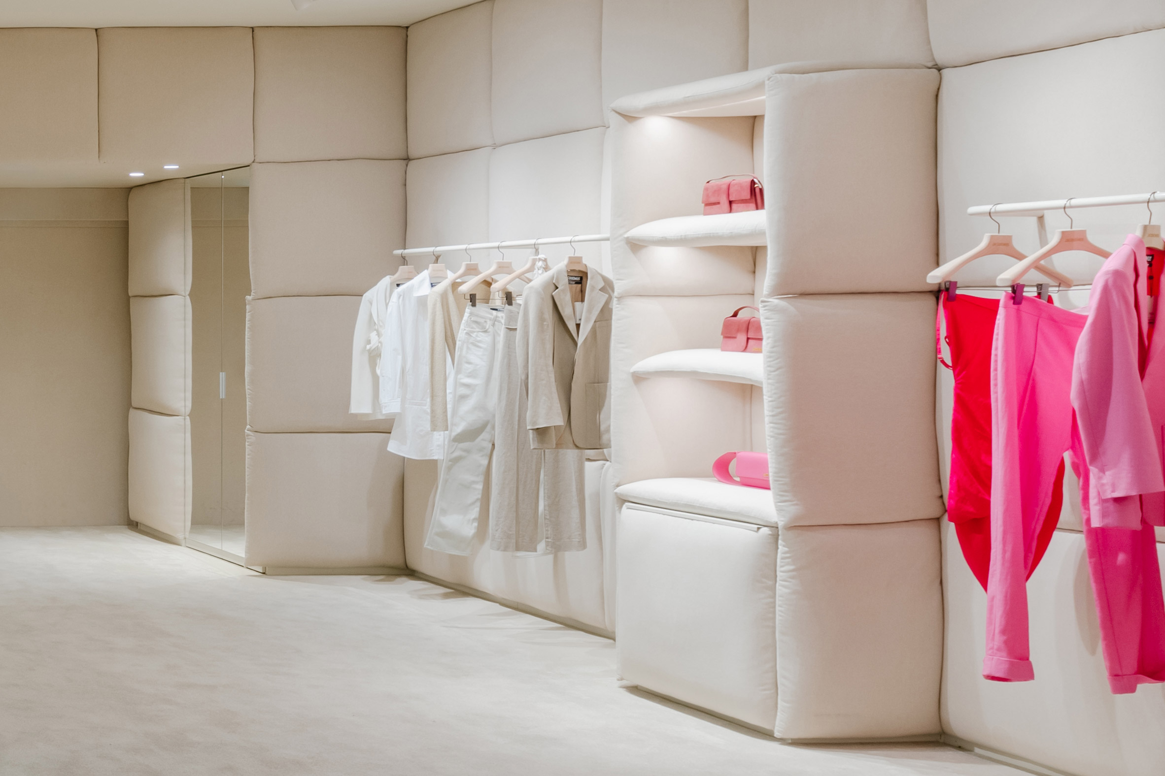 Pink and white clothes displayed in a Jacquemus store