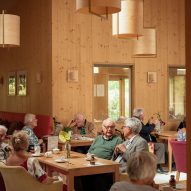 Residents in cafe at John Morden Centre by Mae Architects