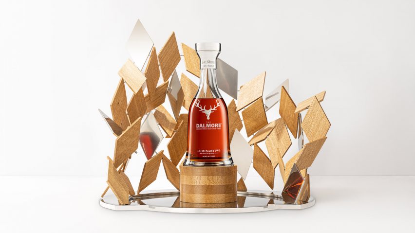 A wooden sculpture around a whisky bottle