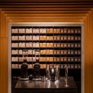 Display unit of coloured coffee bags inside timber frame