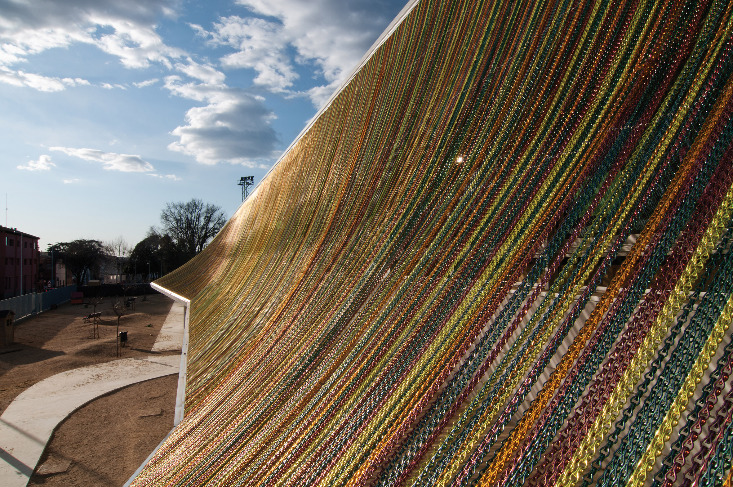 Close-up of the rainbow-coloured aluminium chain canopy on the Can Manent School in Cardedeu, Spain