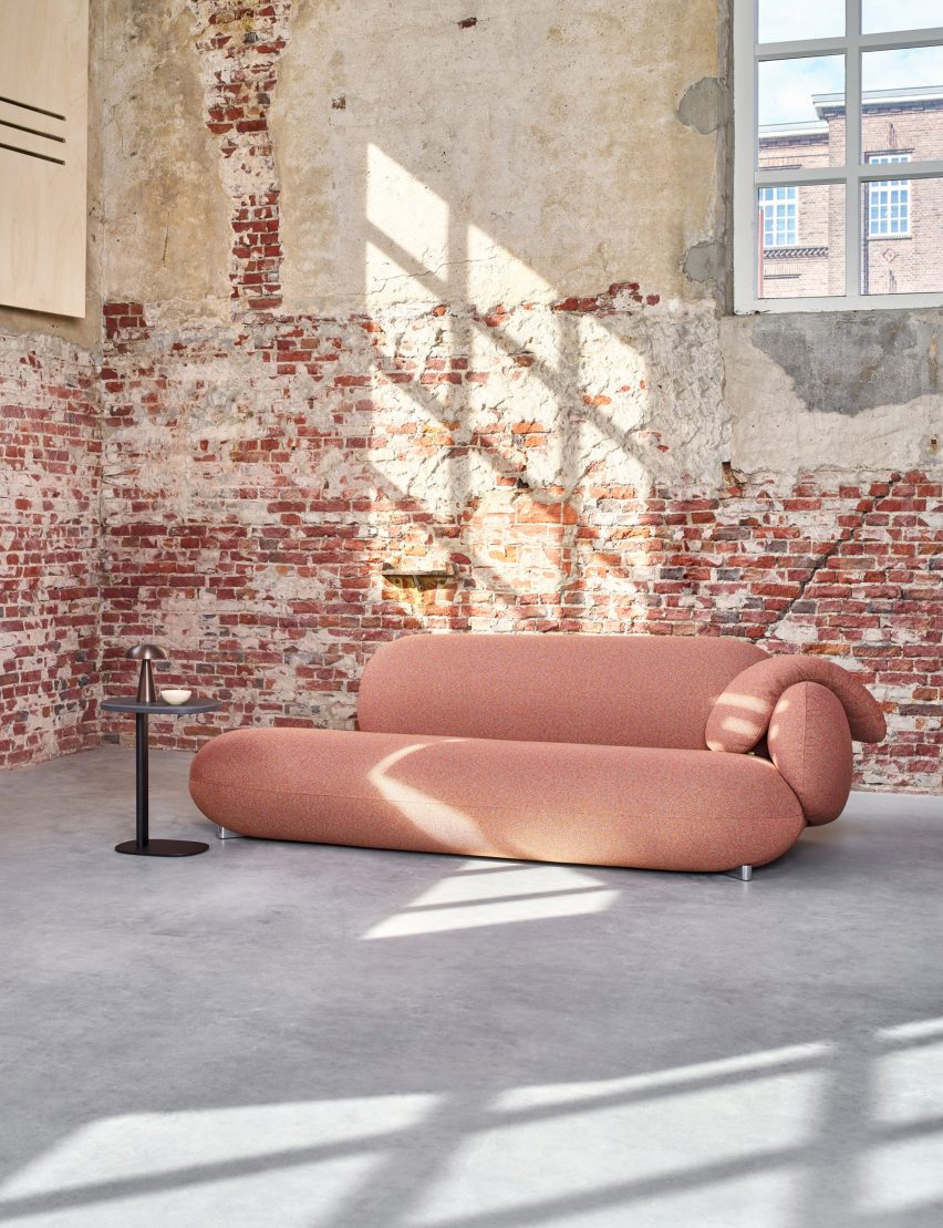 Pink LXR16 sofa by Leolux LX in room with distressed brick walls