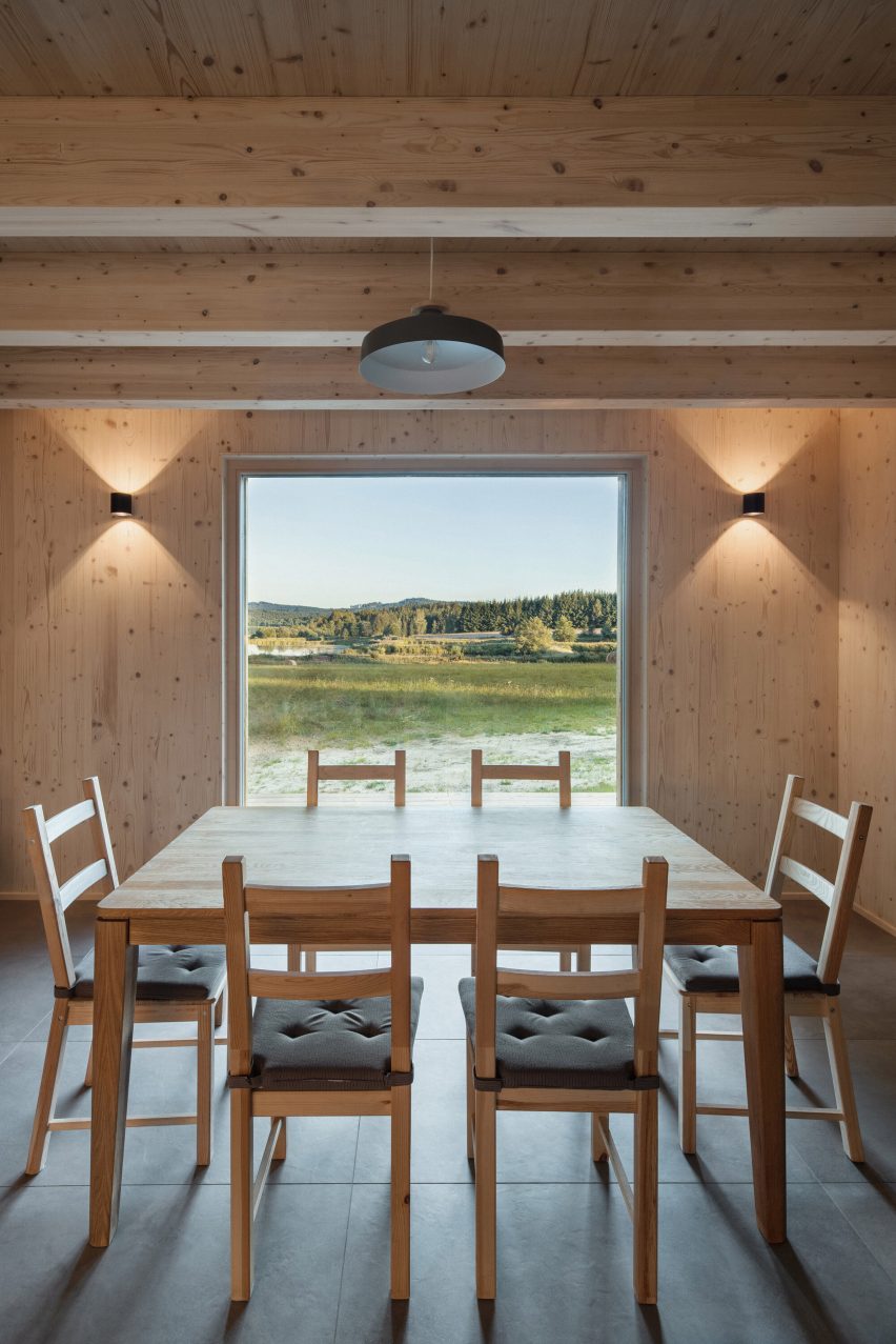 Interior image of the timber-lined dining area at Lipno Lakeside Cabin and its lakeside views