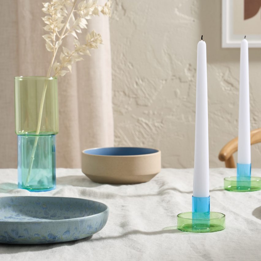 Colourful candlesticks on white cloth