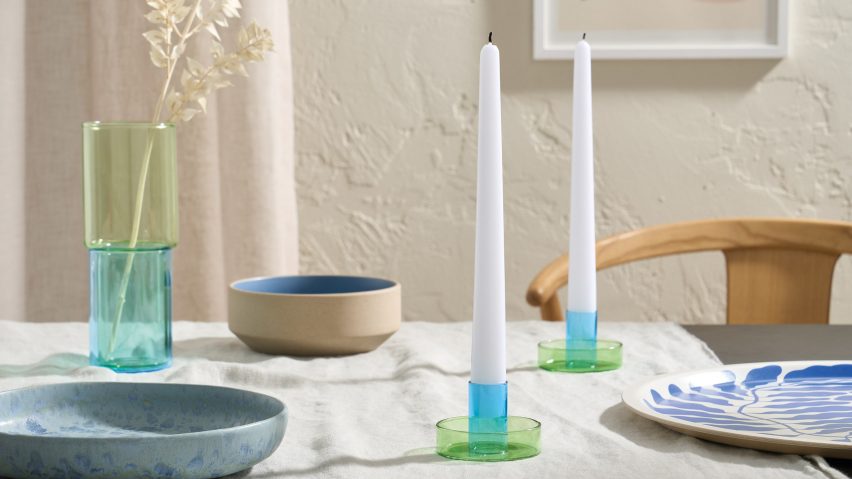 Candlesticks and plates on a table with a white cloth