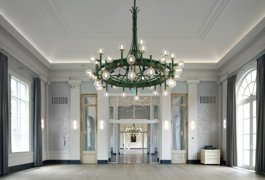 Interior image of a ballroom with a green chandelier at the Groote Museum