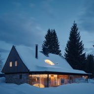 Mjölk Architekti adds "glittering glass extension" to century-old cabin