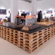 Architectural models on a table made of wooden pallets in Neri&Hu: Reflective Nostalgia exhibition