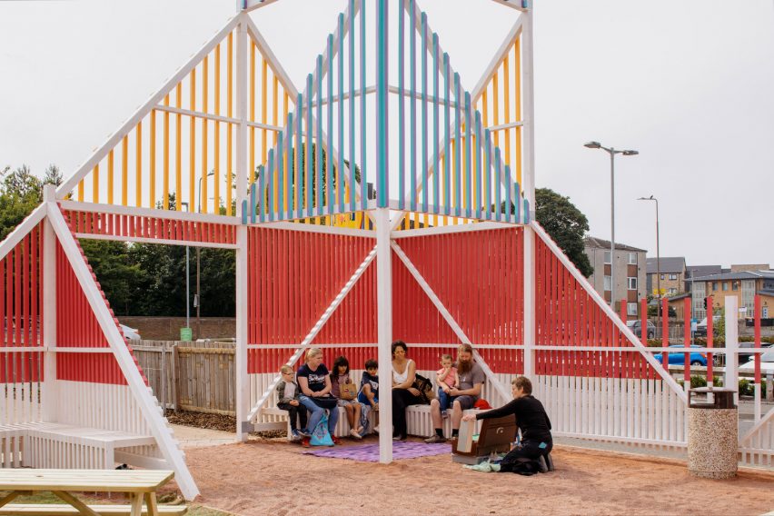 Colourful timber batten structure with seating by New Practice
