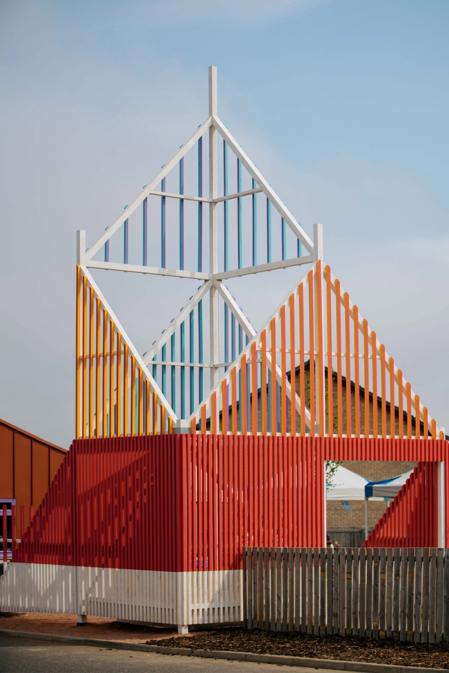 Colourful entrance structure made from timber battens