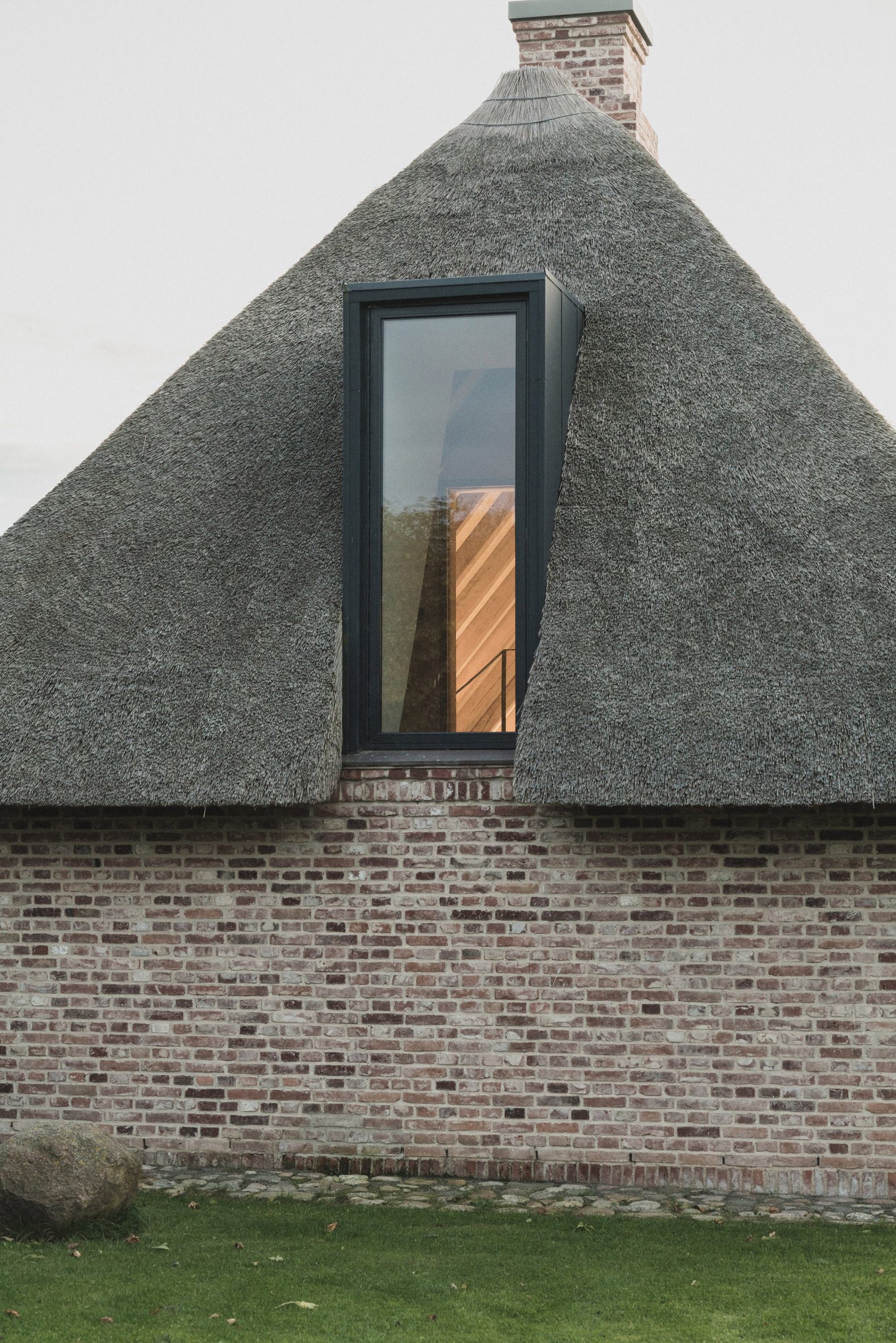 Thatched roof and dormer window in Nieby Crofters Cottage by Jan Henrik Jansen and Marshall Blecher