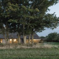 View of Nieby Crofters Cottage by Jan Henrik Jansen and Marshall Blecher through trees
