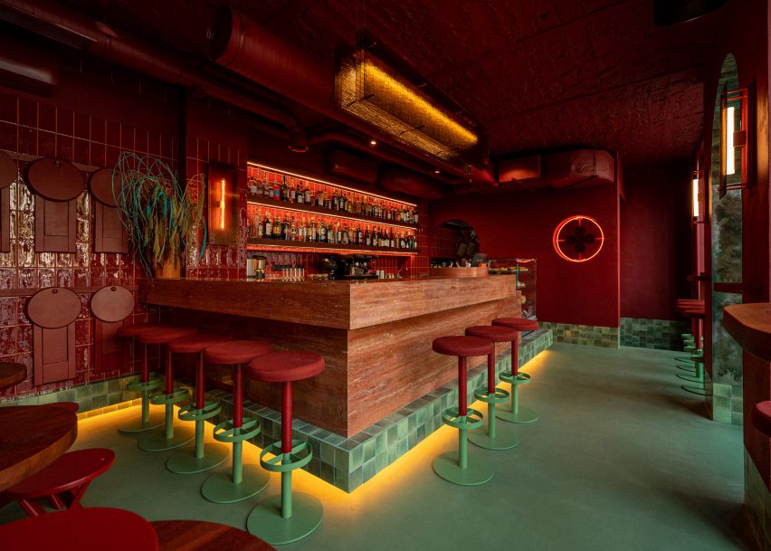 Red travertine bar by Noke Architects