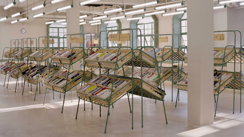 Supermarket-style shelves containing books in the Deja Vu Recycle store in Shanghai by Offhand Practice