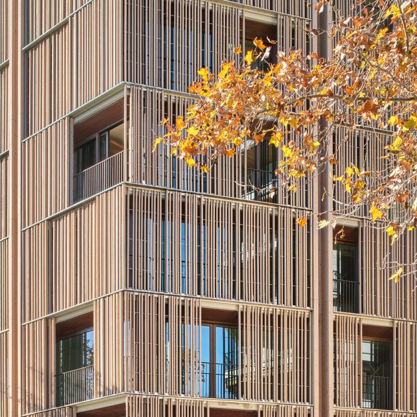 Wood screens and green courtyards define apartment block in Mallorca by OHLAB