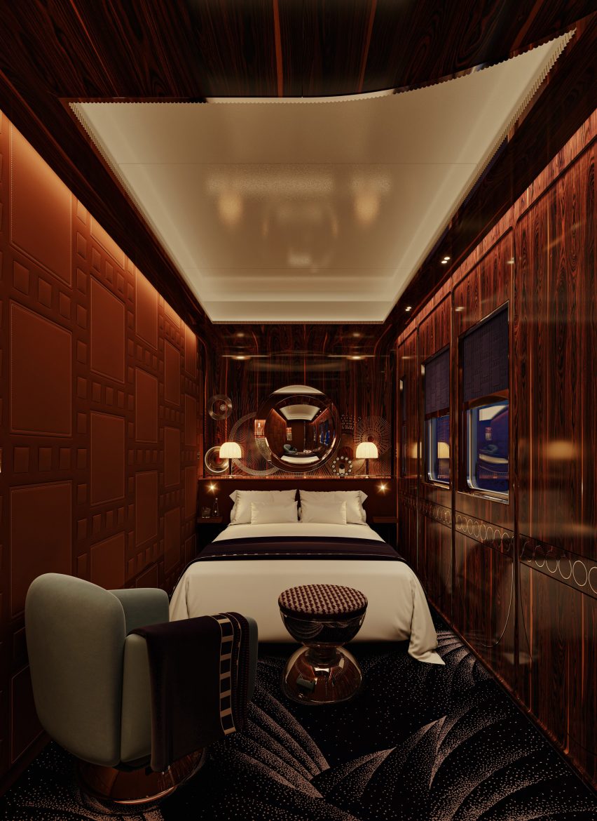 Interior view of the Orient Express train's sleeping area with a large bed and single armchair