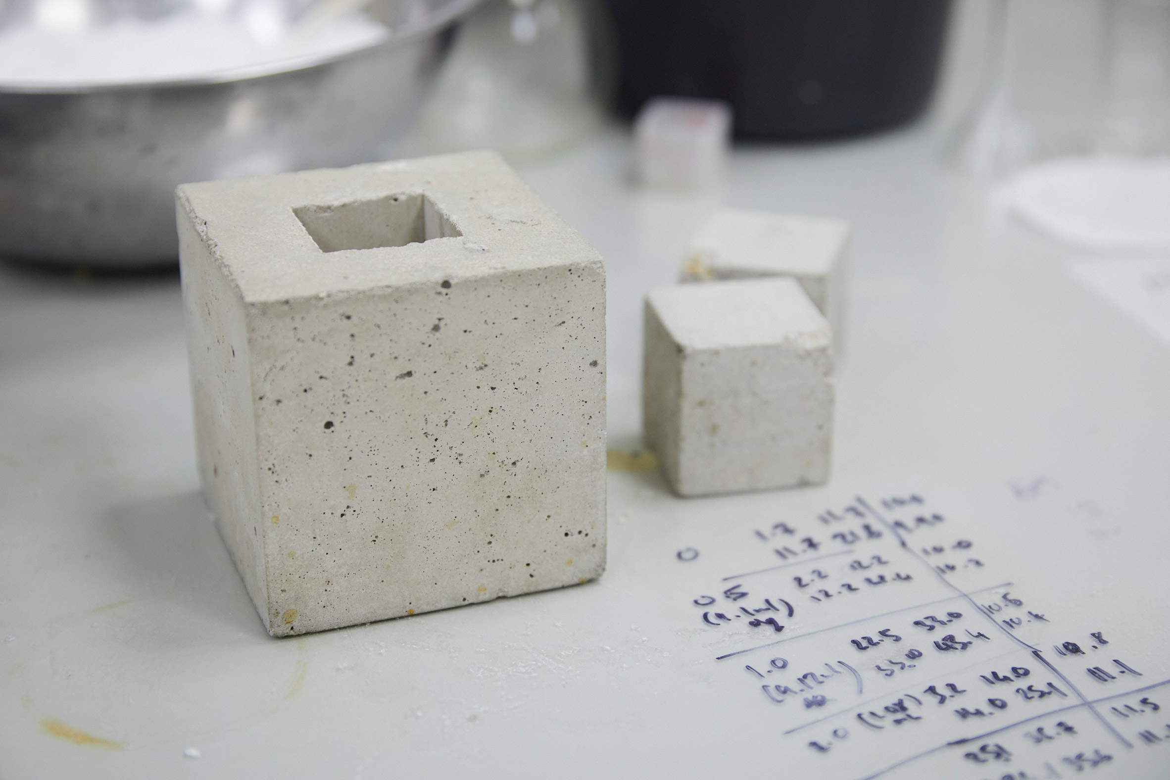 Cubes of Seratech prototype carbon-neutral concrete on a worktable