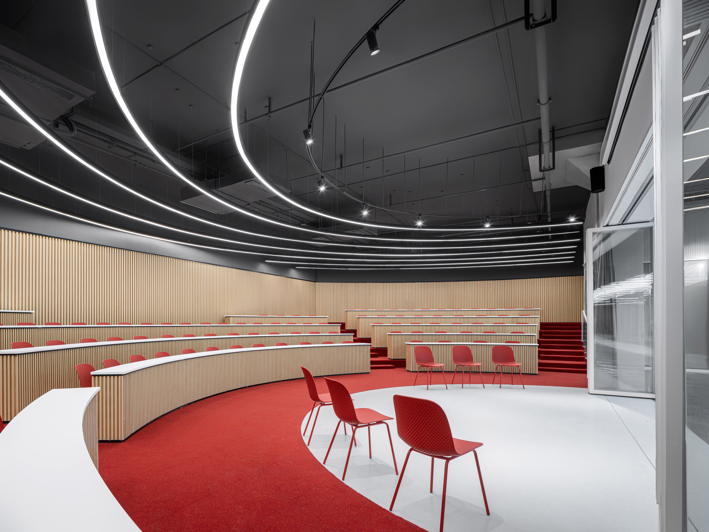 Interior image of an auditorium with red carpet