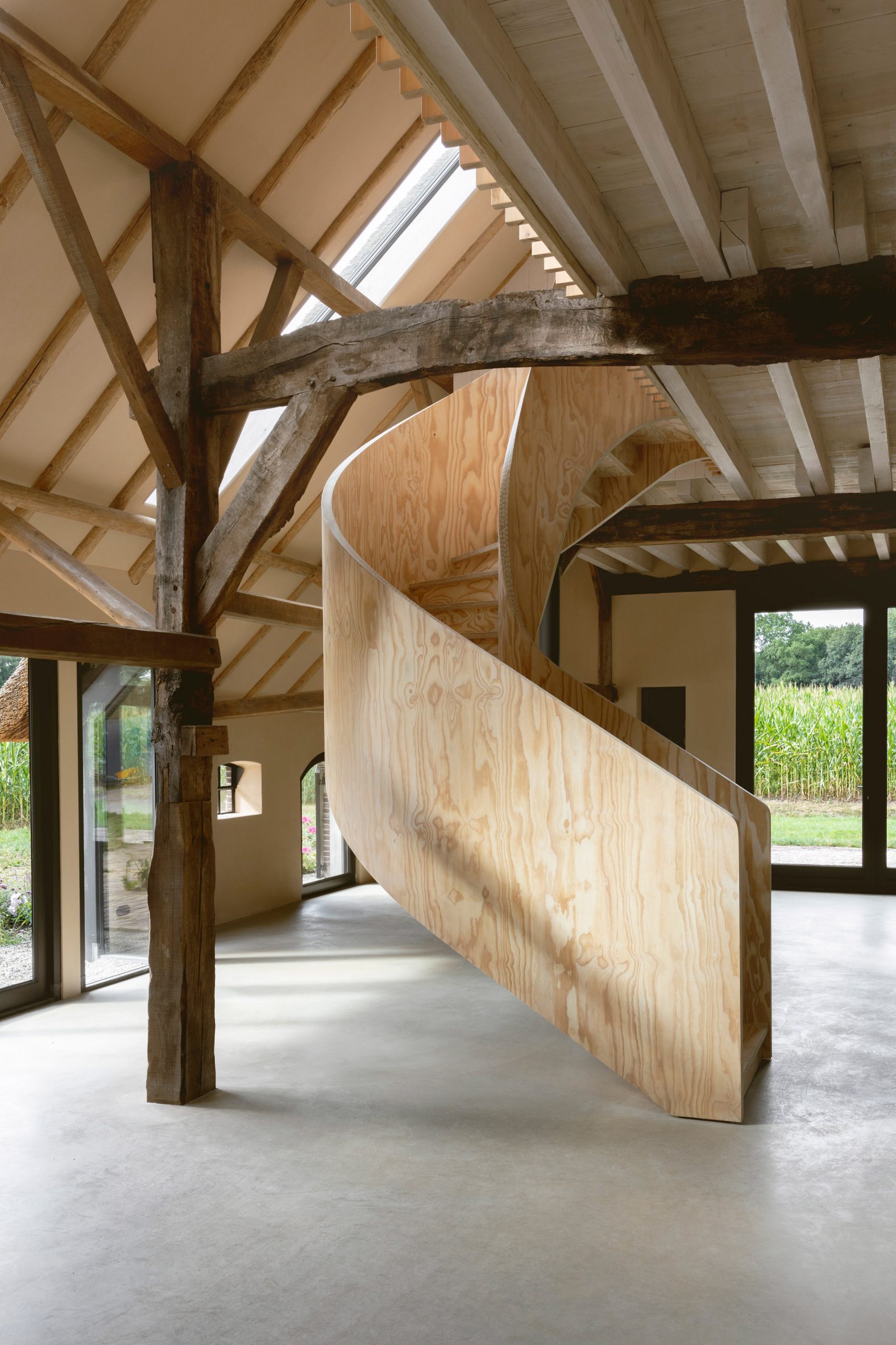 Plywood spiral staircase in Barn at the Ahof by Julia van Beuningen