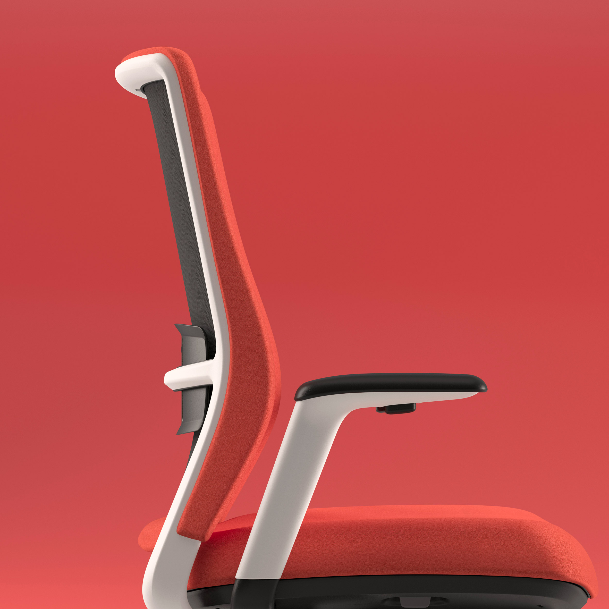 Red desk chair in profile in front of red background