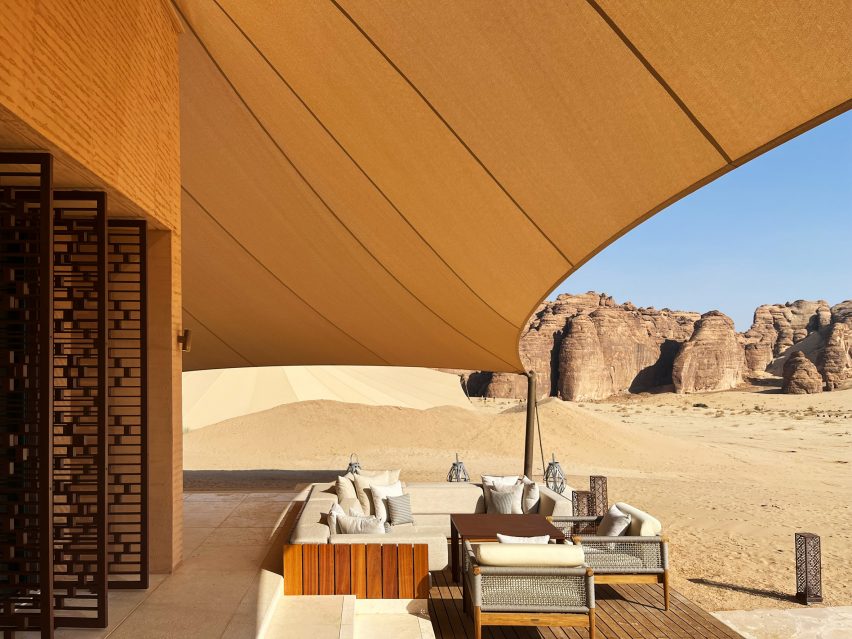 Terrace beneath tent-like roof of desert resort by AW2