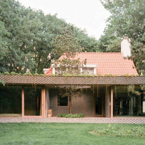 Brick extension opens rural Dutch home out towards a forested garden