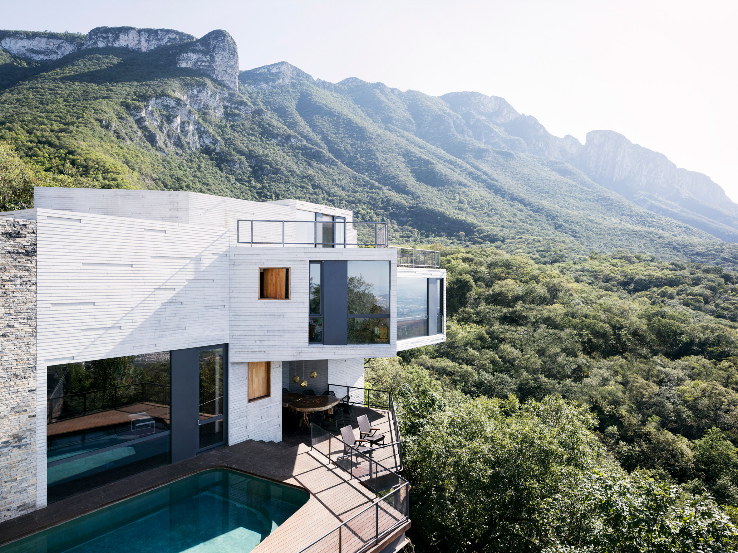 Casa Ventura outdoor area with swimming pool and cantilevered structures set against the surrounding landscape