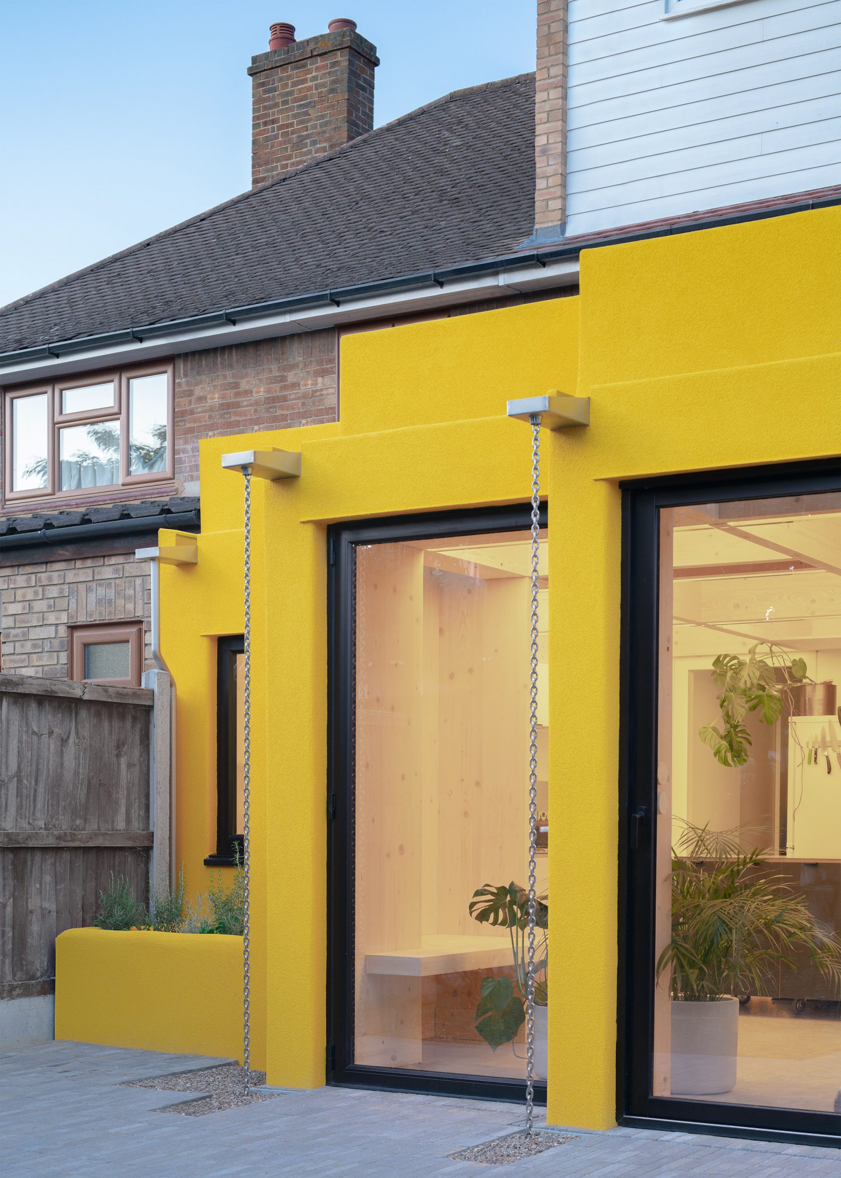 Yellow rear extension to CLT House by Unknown Works