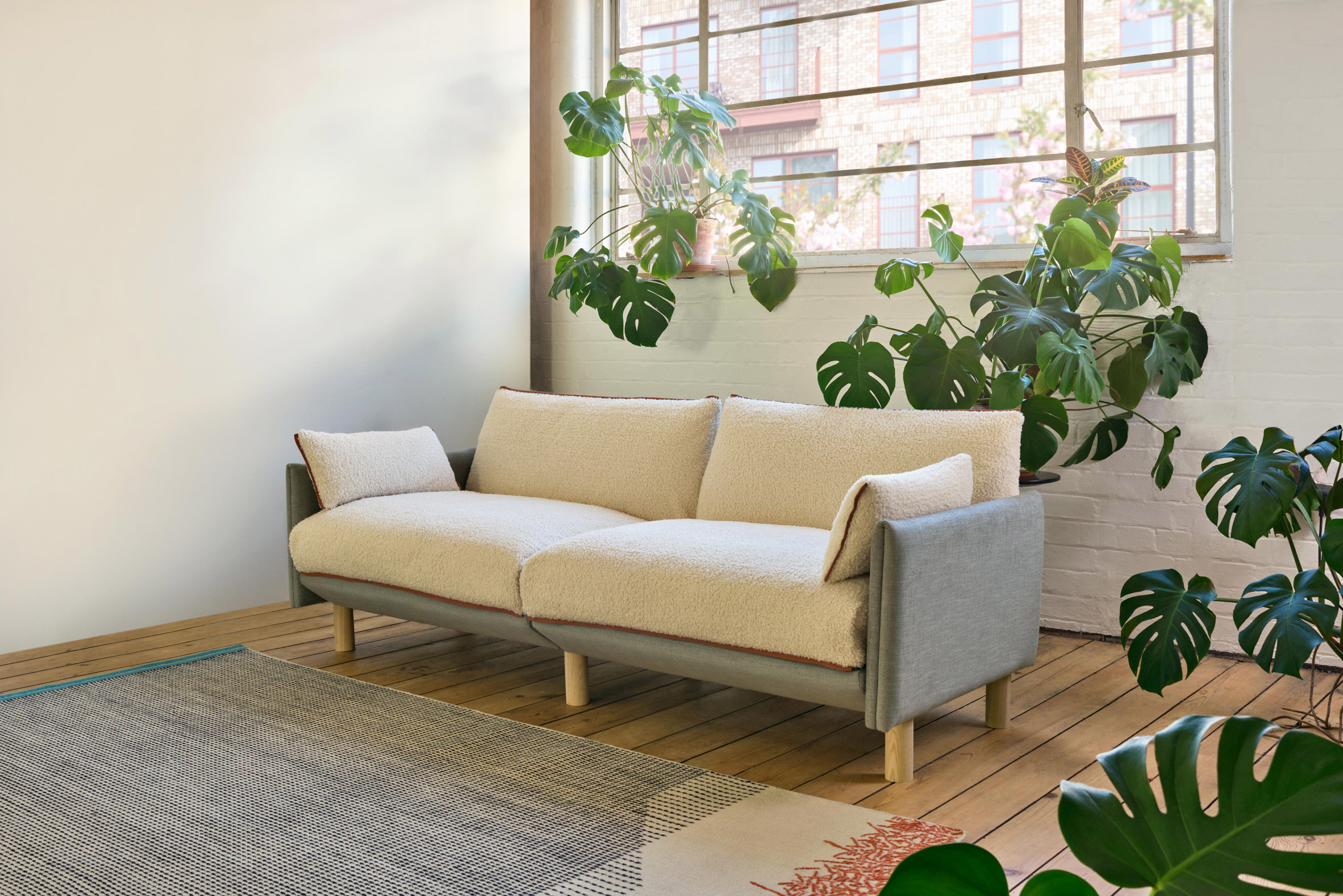 Sofa with white cover in room with plants