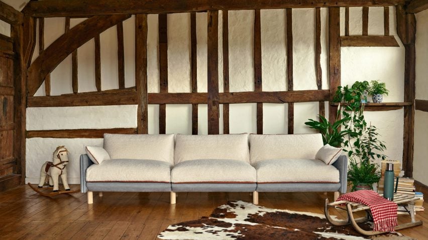 Sofa with white cover in room with beams