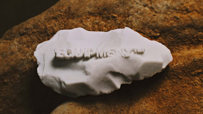A grey 3D-printed stone with the word Equipment on it