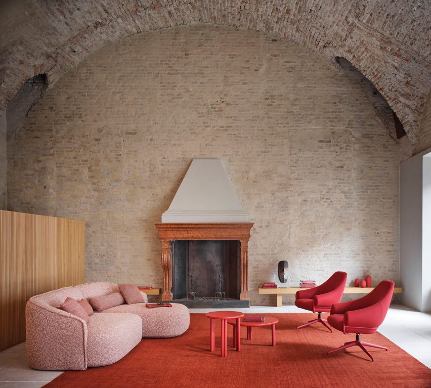 Red chair in minimal interior with fireplace and sofa