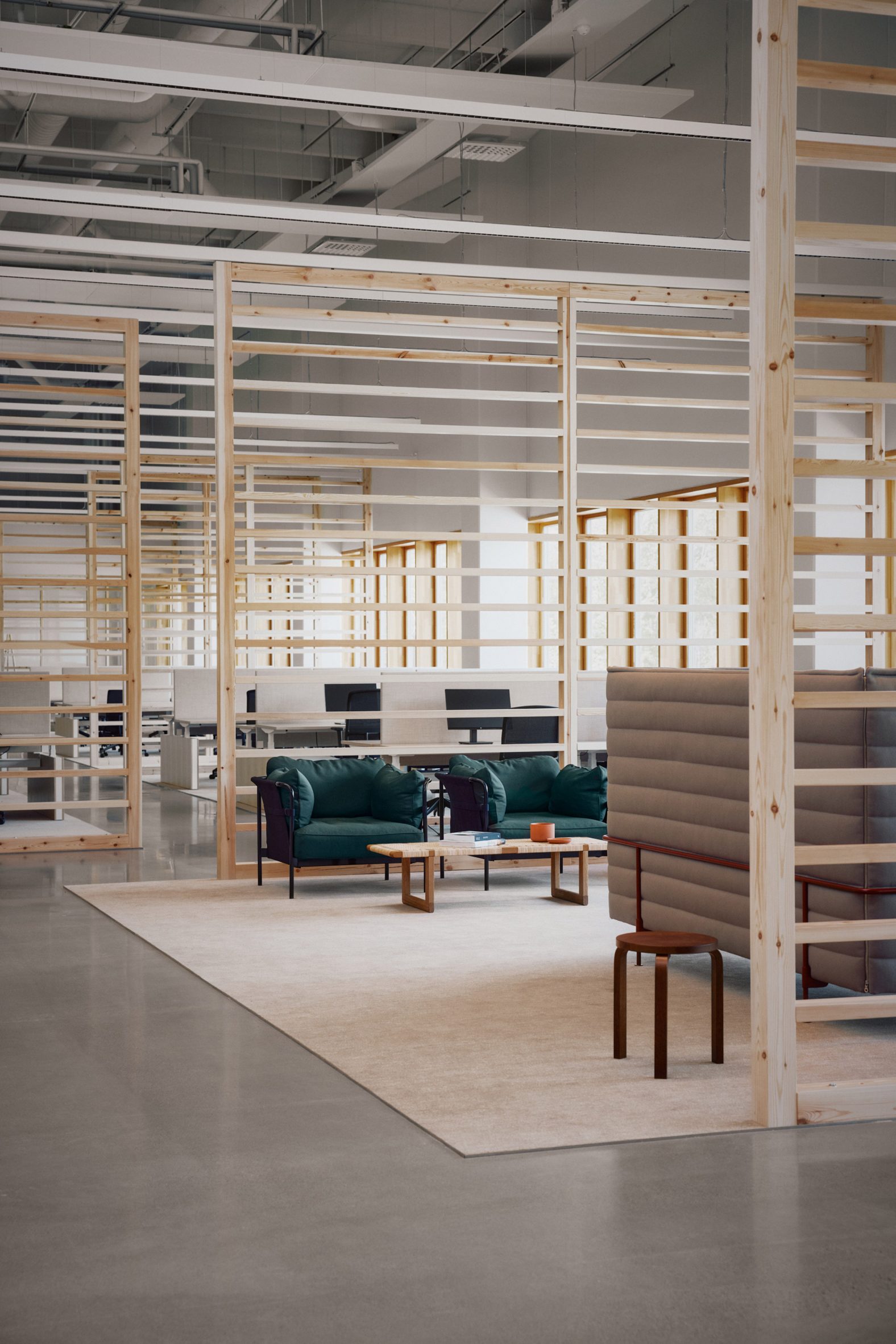 Photo of an open office area with slatted pale wood room dividers and soft furnishings in neutral colours and turquoise