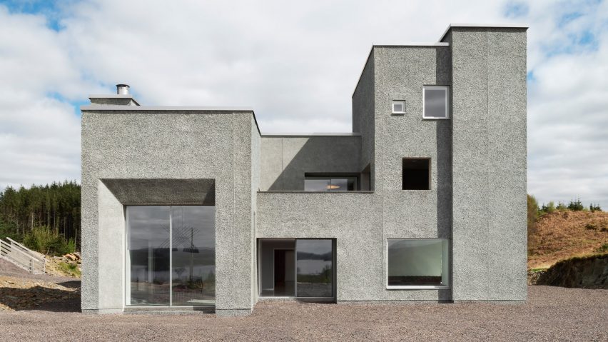 Grey pebble dash house with large glazed doors and windows