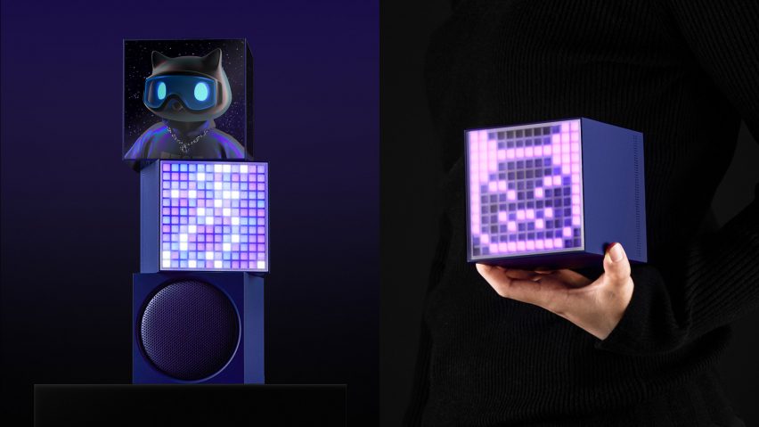 Photograph of hand-held pixel device showing cat face and stacked cubes in the background