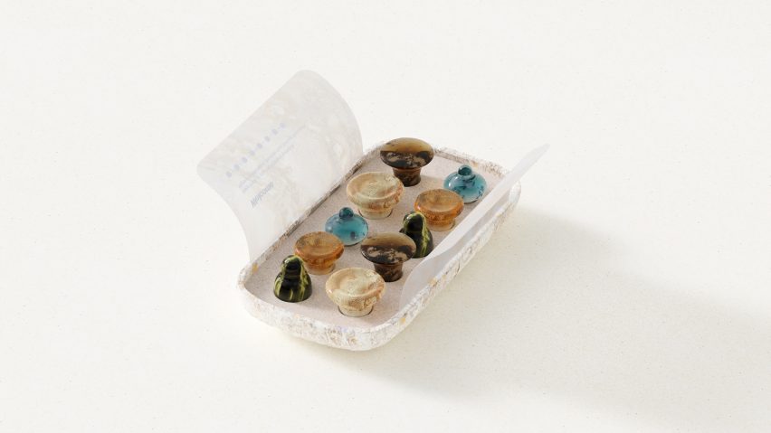 Rendering of an opened package of Keia psilocybin lozenges to reveal 10 marbled microdose gummy candies of various shapes