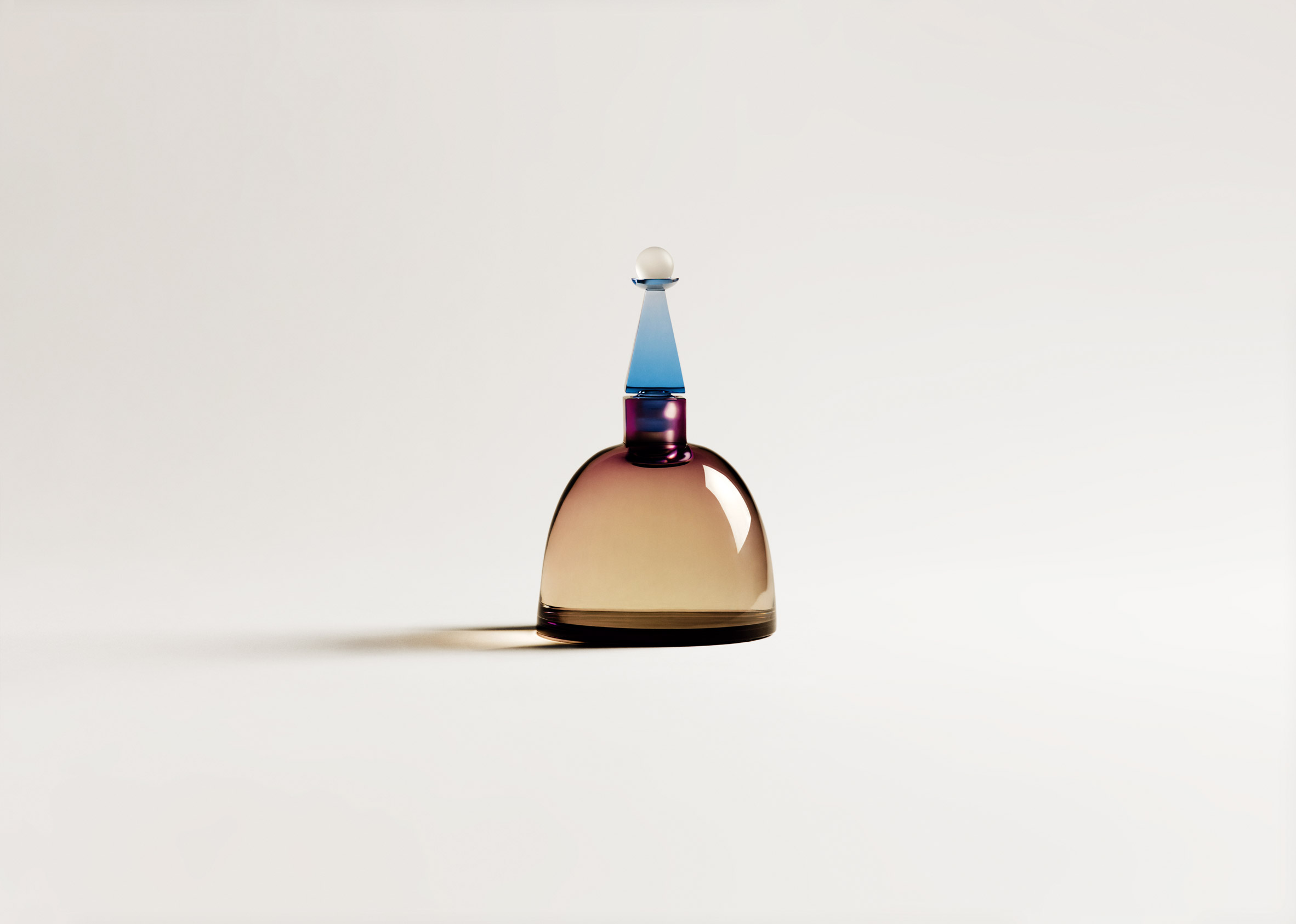 A coloured glass bottle of perfume