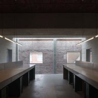 Built-in desks in room with brick walls