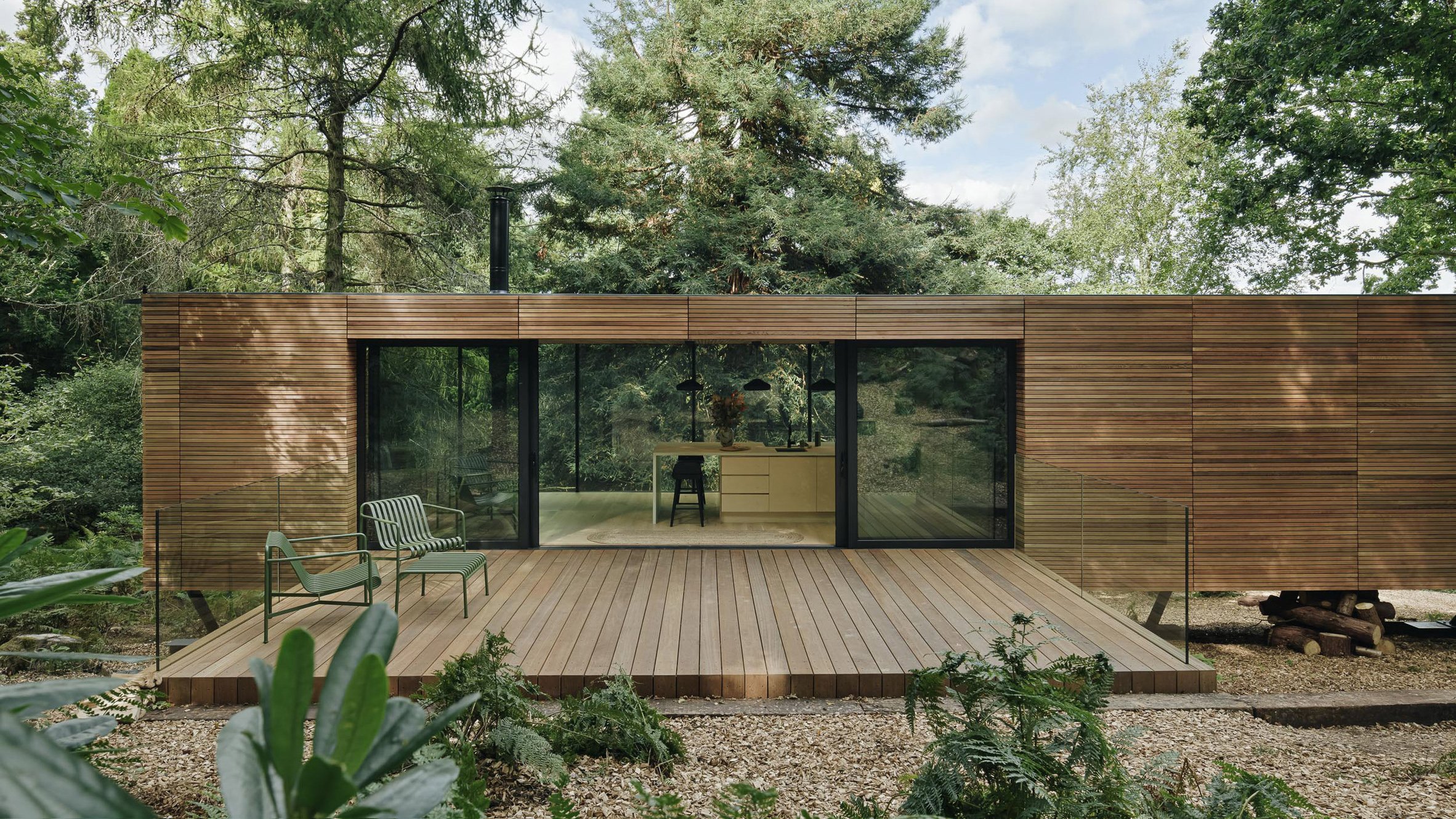 Wooden house with glass windows in forest
