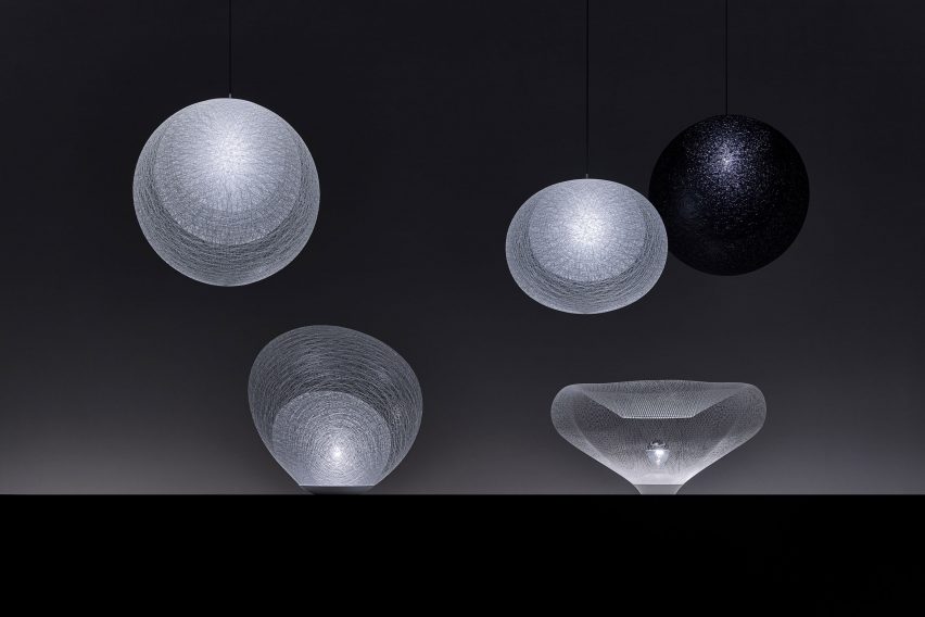 A series of nest-like lamps on a dark background