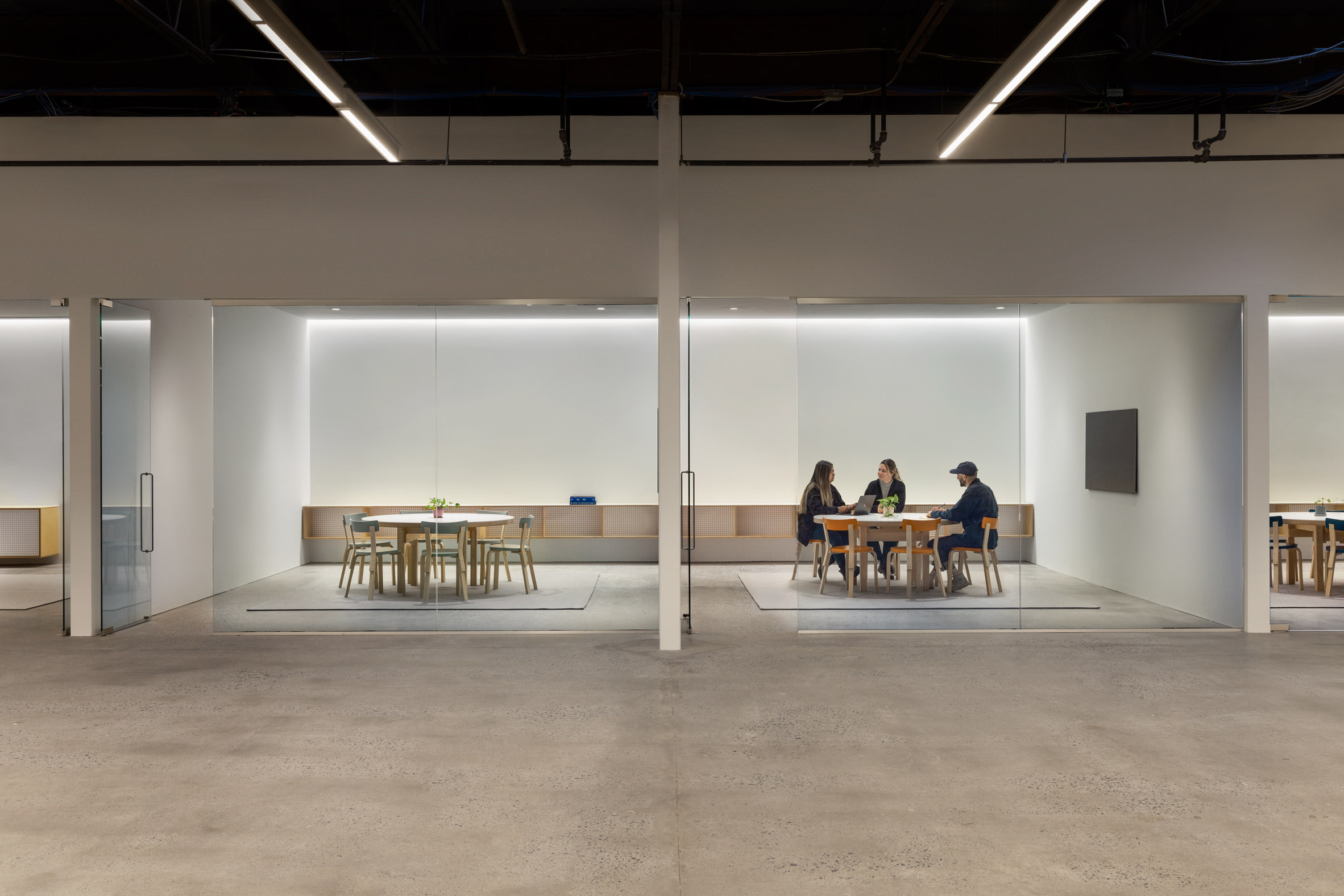 Offices with glass walls and industrial ceilings