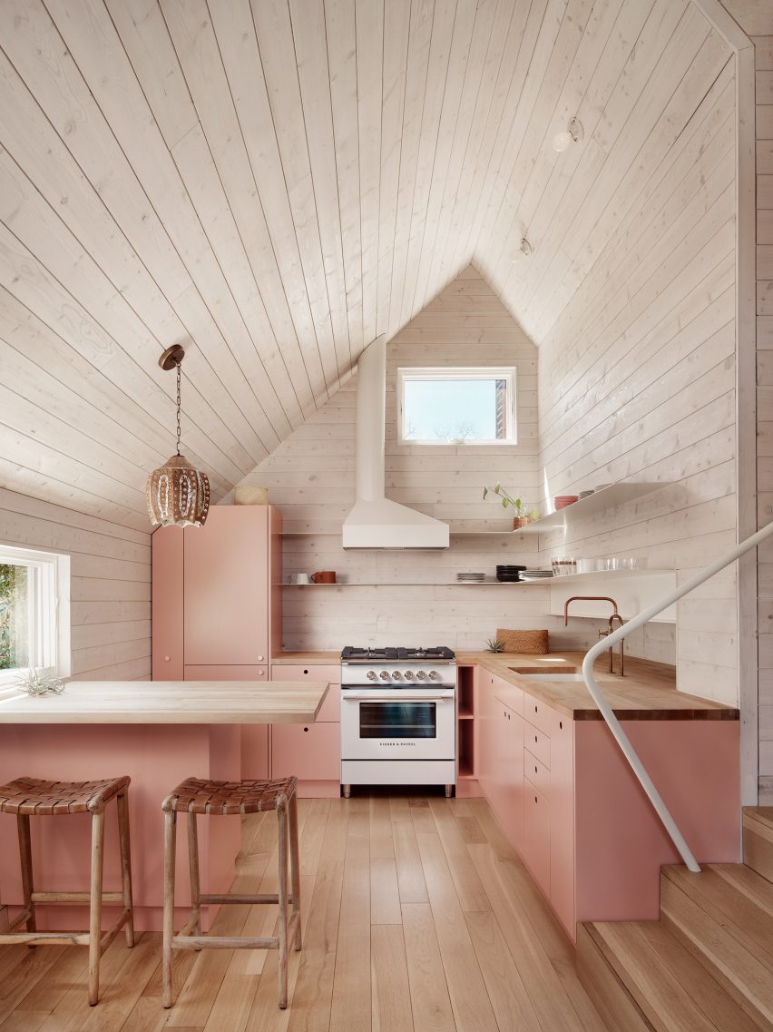 A pink and white kitchen inside The Perch