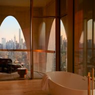 Bathroom with arch-framed view of Manhattan