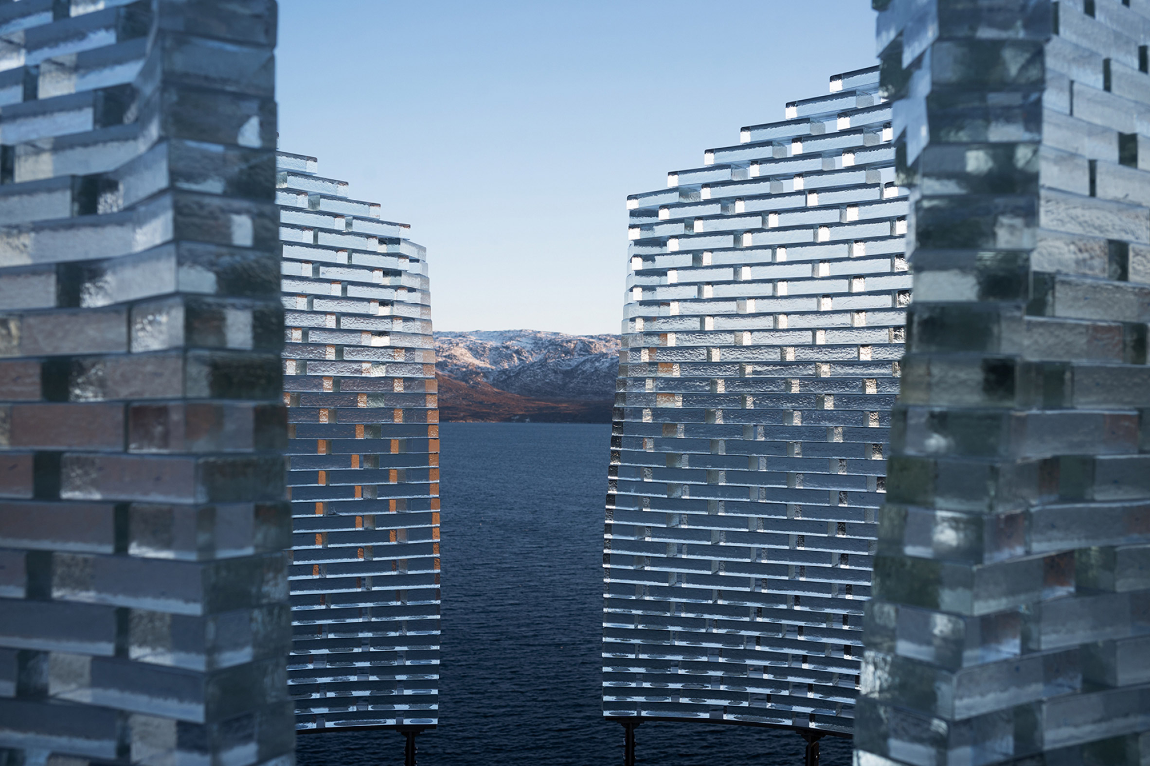 Glass block walls of the Qaammat pavilion by Konstantin Arkitekter overlooking a lake