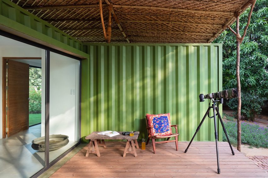 Image of a deck area that is covered by a wooden roof at The Container House