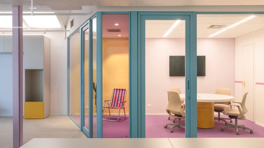 Meeting room with pink carpet and teal window frames