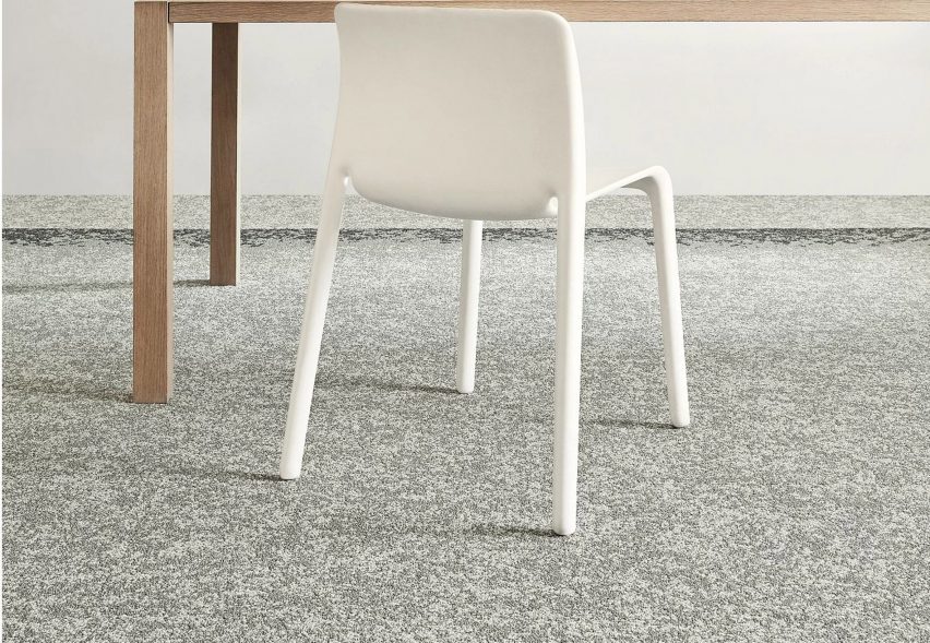 Shifting Fields carpet tiles by Shaw Contract with a white chair